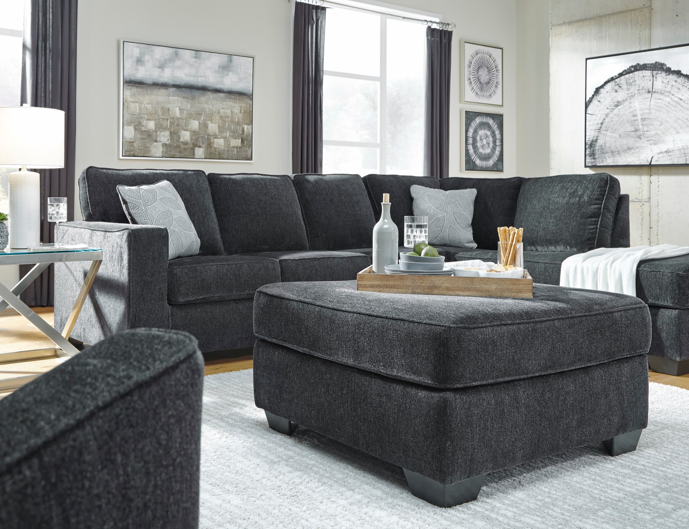 Grey L-shaped fabric sectional couch with a chaise in a living room